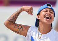 <p>That's dedication! Margielyn Didal of the Philippines celebrates shows off one special tattoo during the women's street final in skateboarding on July 26.</p>