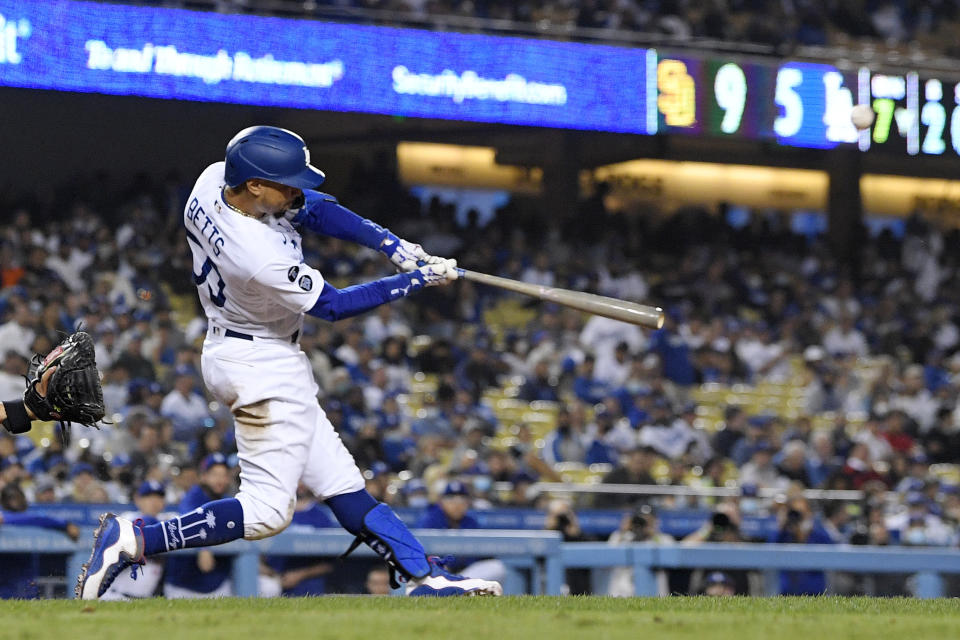 Los Angeles Dodgers' Mookie Betts hits a solo home run during the seventh inning of a baseball game against the San Diego Padres Wednesday, Sept. 29, 2021, in Los Angeles. (AP Photo/Mark J. Terrill)