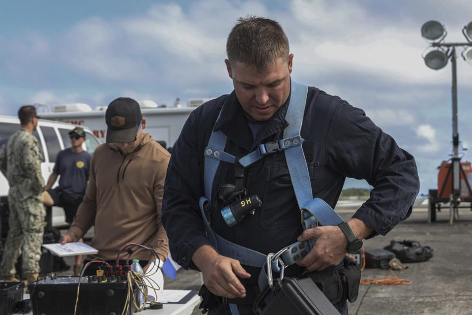 This photo provided by U.S. Marine Corps, A U.S. Navy Sailor with Company 1-3, Mobile Diving and Salvage Unit 1, prepares diving equipment to retrieve the aircraft flight recorder from a downed U.S. Navy P-8A Poseidon in waters just off the runway at Marine Corps Air Station Kaneohe Bay, Marine Corps Base Hawaii, Thursday, Nov. 23, 2023. The flight data recorder has been recovered as the military continues to plan for the aircraft’s removal.(Lance Cpl. Hunter Jones/U.S. Marine Corps via AP)