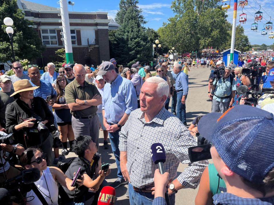 Former Vice President Mike Pence takes questions from reporters at the Iowa State Fair on Friday, Aug. 11, 2023.