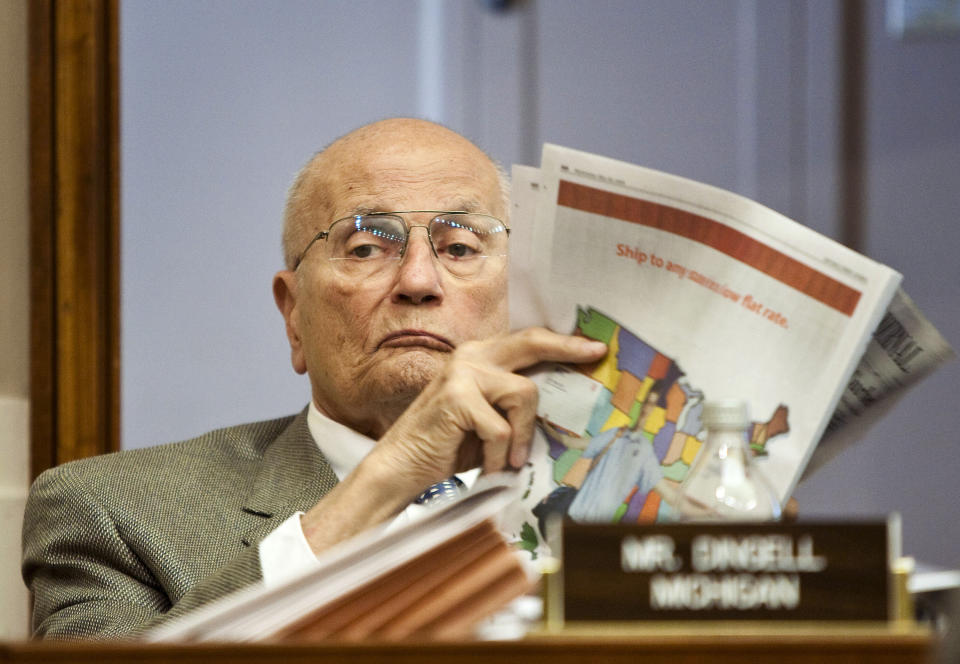 Dingell reads a newspaper during a House Energy and Commerce Committee markup session on the Greenhouse Gas Emission Reduction Act on May 20, 2009.