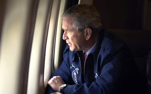 George W Bush looks at the damage caused by Hurricane Katrina - Credit: REUTERS/Mannie Garcia