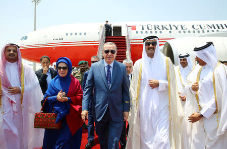 Turkish President Tayyip Erdogan, accompanied by his wife Emine Erdogan, is welcomed by Emir of Qatar Sheikh Tamim Bin Hamad Al-Thani in Doha, Qatar, July 24, 2017. Kayhan Ozer/Presidential Palace (Turkey)/Handout via REUTERS