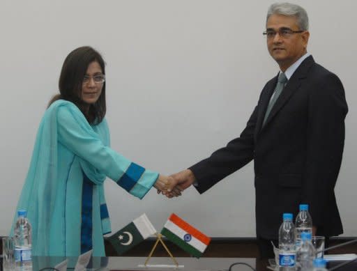 Indian defence official Shashikant Sharama (right) shakes hands with his Pakistani counterpart Nargis Saithi before start of talks at the Defence Ministry in Rawalpindi. Indian and Pakistani defence officials have held a fresh round of talks seeking to end decades of dispute over the Siachen Glacier, dubbed the world's highest battlefield