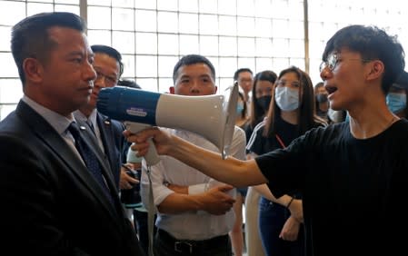 Students at Hong Kong Baptist University take part in a rally after police entered the campus on Sunday while chasing protesters, in Hong Kong