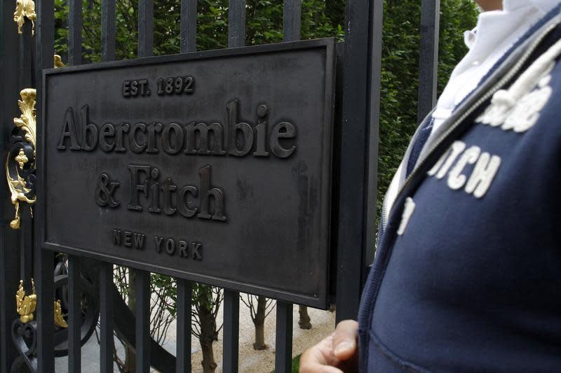 An employee stands outside the Champs Elysees store of clothing retailer Abercrombie & Fitch on opening day in Paris May 19, 2011. REUTERS/Benoit Tessier