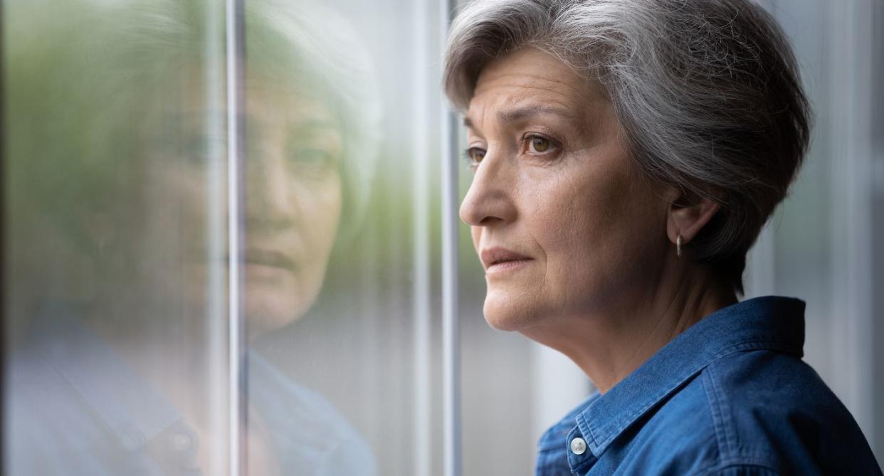 Broken heart syndrome - woman looking sad outside window. (Getty Images)