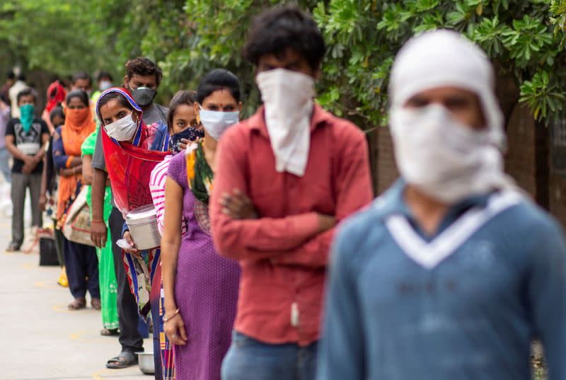 FILE PHOTO: People queue for food during the coronavirus outbreak in New Delhi, India