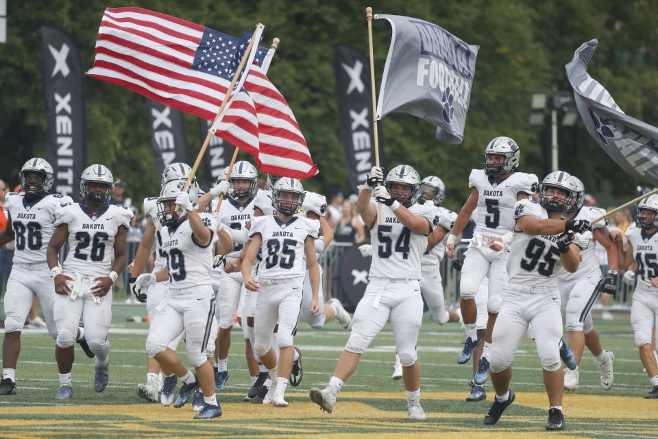 Macomb Dakota takes the field before action against Birmingham Brother Rice in the Xenith Prep Kickoff Classic at Tom Adams Field at Wayne State in Detroit on Thursday, Aug. 25, 2022.