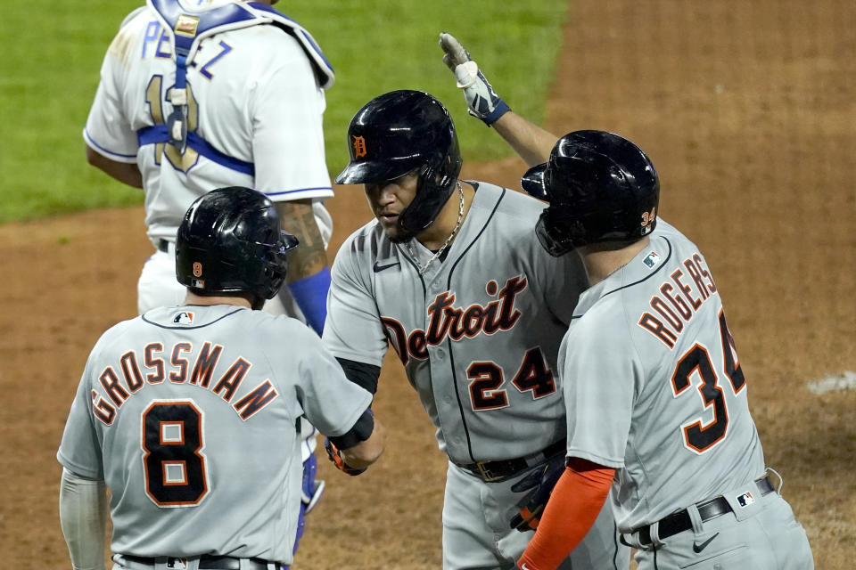 Detroit Tigers' Miguel Cabrera (24) celebrates with Robbie Grossman (8) and Jake Rogers after hitting a grand slam during the seventh inning of a baseball game against the Kansas City Royals Friday, May 21, 2021, in Kansas City, Mo. (AP Photo/Charlie Riedel)