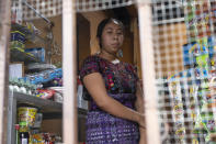 Kakchiquel Indigenous Nancy Noj, 18, poses for a photo in the tortilla shop where she is employed, in Guatemala City, Tuesday, Oct. 5, 2021. Noj said she had only been working there for about a year. It is her aunt’s business. “I don’t see it like work, but rather like helping my aunt,” she said. (AP Photo/Moises Castillo)