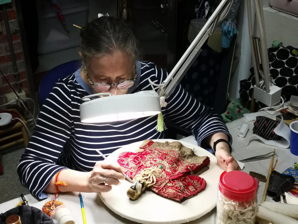 Conservator Kim Siebert restores an antique puppet at the Taiyuan Asian Puppet Theatre Museum in Taipei, Taiwan.