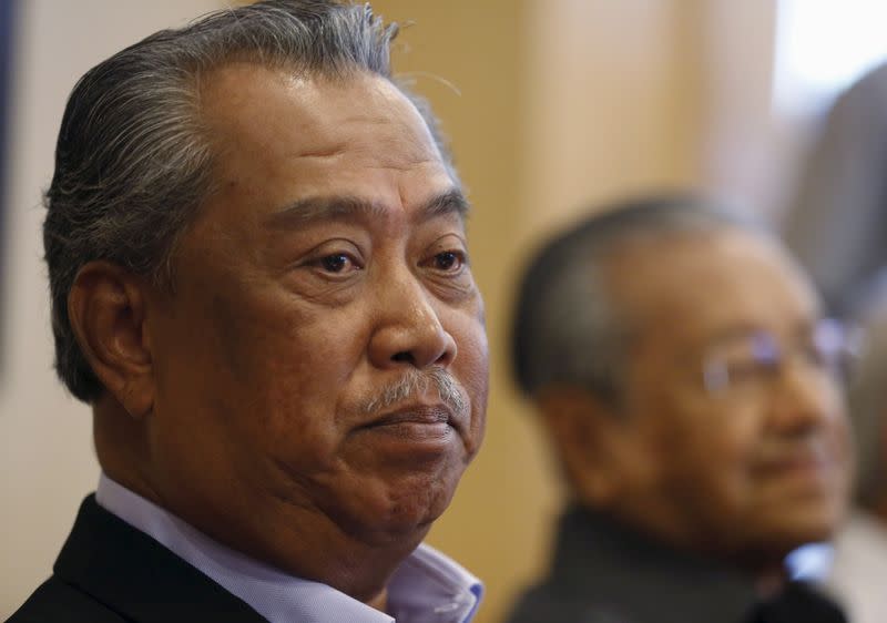 UMNO's Deputy President Muhyiddin Yassin and former prime minister Mahathir Mohamad give a news conference in Putrajaya
