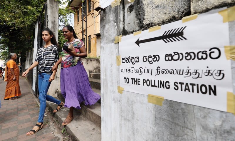 People leave after casting their votes during the presidential election, at a polling station in Colombo