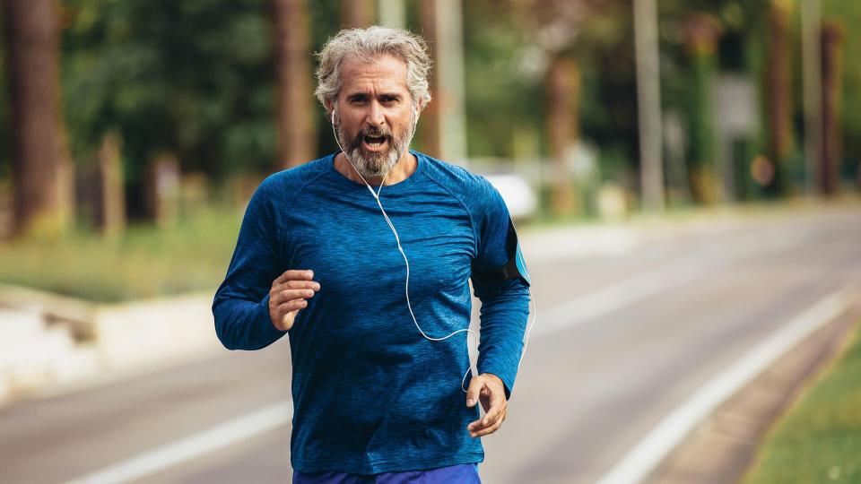 Active senior man jogging on a sunny day.