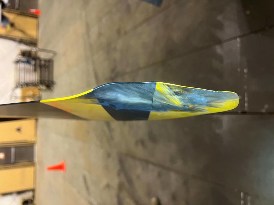 The Reaper drone's black-and-yellow propeller with scuffs and scratches.