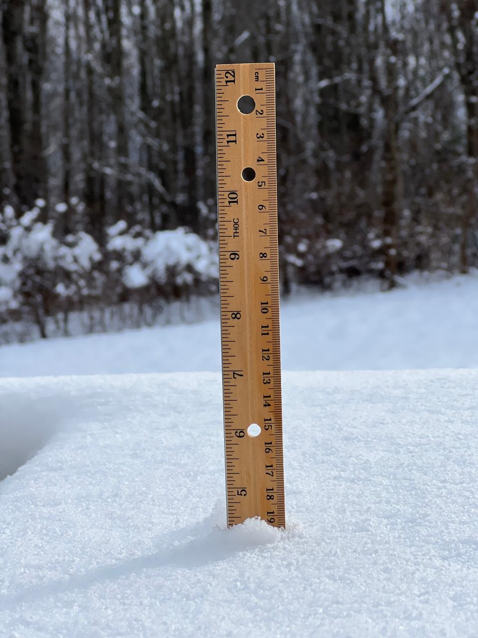 A ruler shows snow at about 4-and-a-half inches deep on Dec. 12, 2023 in Williston following a snowstorm that ended the previous evening.