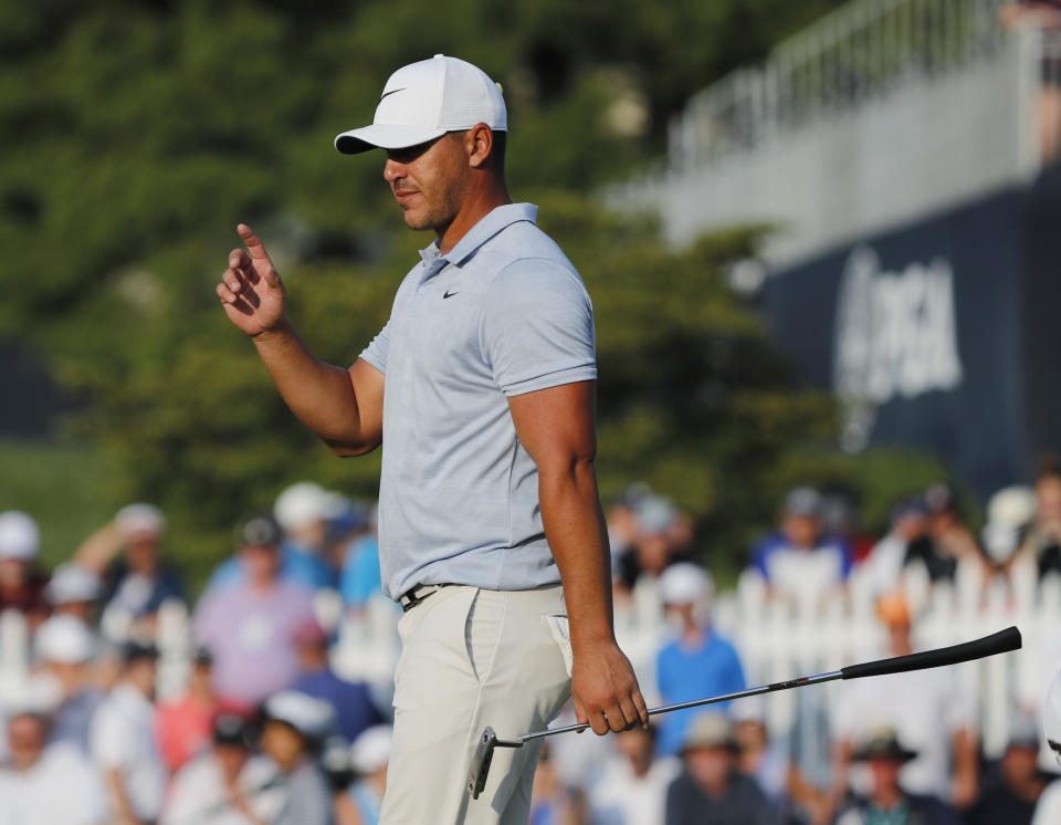 Brooks Koepka acknowledges the gallery as he walks to the 18th green during the third round of the PGA Championship golf tournament at Bellerive Country Club, Saturday, Aug. 11, 2018, in St. Louis. (AP Photo/Brynn Anderson)