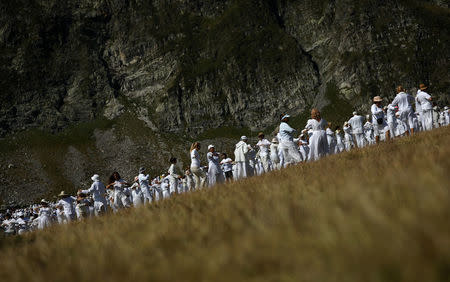 Followers of the Universal White Brotherhood, an esoteric society that combines Christianity and Indian mysticism set up by Bulgarian Peter Deunov in the 1920s, perform a dance-like ritual called "paneurhythmy" in Rila Mountain, Bulgaria, August 19, 2017. REUTERS/Stoyan Nenov