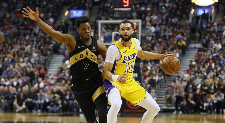 Jan 28, 2018; Toronto, Ontario, CAN; Los Angeles Lakers guard Tyler Ennis (10) tries to get around Toronto Raptors guard Kyle Lowry (7) during the first half at the Air Canada Centre. Mandatory Credit: John E. Sokolowski-USA TODAY Sports