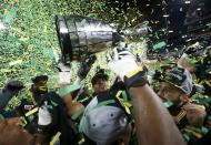 Edmonton Eskimos players raise the Grey Cup after they defeated the Ottawa Redblacks in the CFL's 103rd Grey Cup championship football game in Winnipeg, Manitoba, November 29, 2015. REUTERS/Mark Blinch