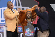 Former NFL player Richard Seymour, left, and his high school principal Titus Durea unveil his bust before speaking during his induction into the Pro Football Hall of Fame, Saturday, Aug. 6, 2022, in Canton, Ohio. (AP Photo/David Richard)