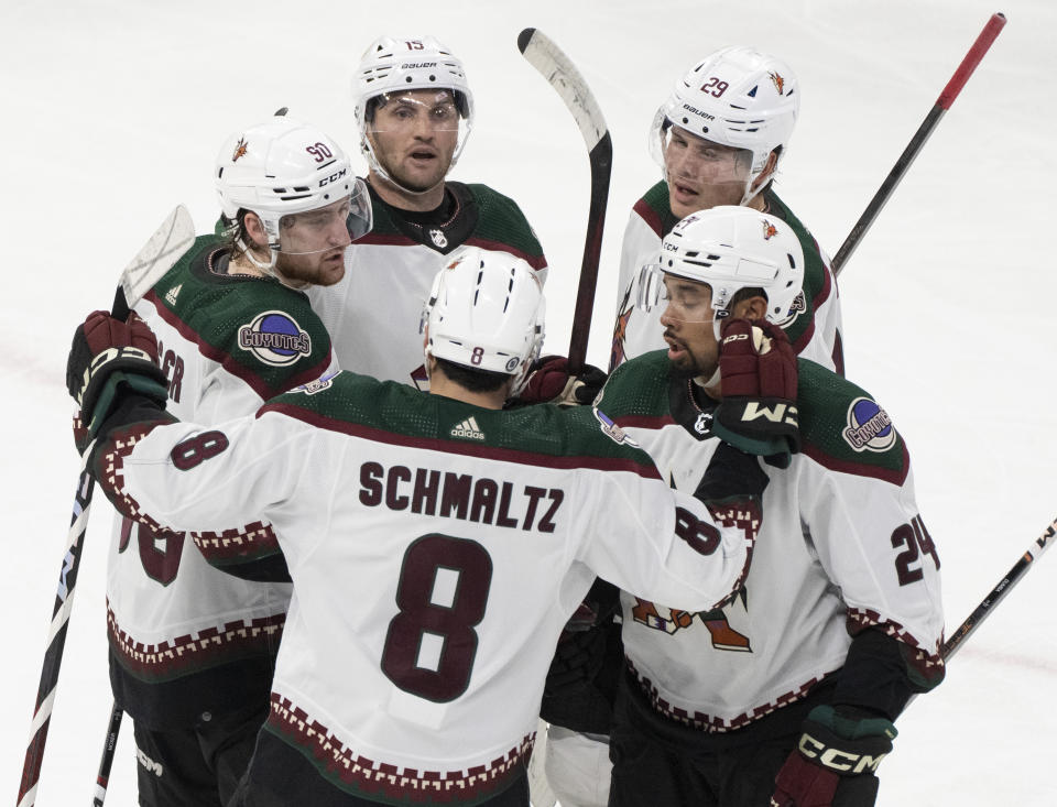 Arizona Coyotes' Alex Kerfoot (15) celebrates his goal against the Montreal Canadiens with teammates J.J. Moser (90), Nick Schmaltz (8), Matt Dumba (24) and Barrett Hayton (29) during the second period of an NHL hockey game in Montreal, Tuesday, Feb. 27, 2024. (Christinne Muschi/The Canadian Press via AP)