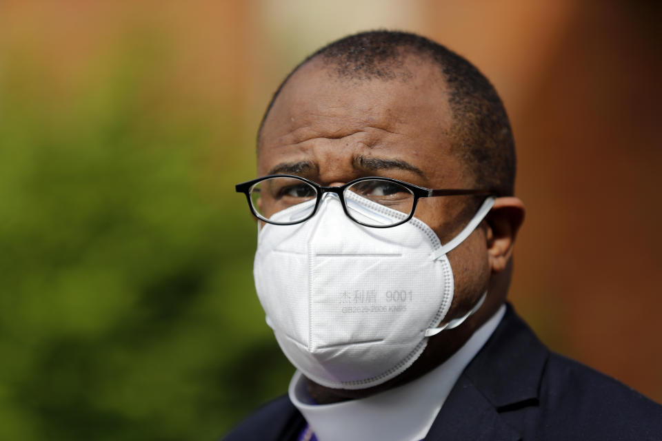 Bishop Elijah Hankerson, president of the St. Louis Metropolitan Clergy Coalition, watches as various pastors and church leaders drive up to pick up free face masks for their congregations Thursday, May 28, 2020, in Hanley Hills, Mo. The masks were provided by St. Louis city and county and by the state of Missouri at the request of Darryl Gray, a St. Louis activist and pastor, to help area churches prepare to restart services as restrictions surrounding the coronavirus outbreak ease. (AP Photo/Jeff Roberson)