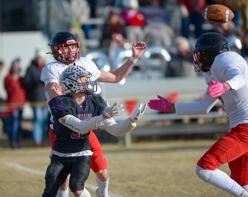 Power/Dutton/Brady's Spencer Lehnerz attempts to make a catch as Medicine Lake/Froid Mason Dethman and Javonne Nesbit defend during the 6-Player football championship on Saturday in Dutton.