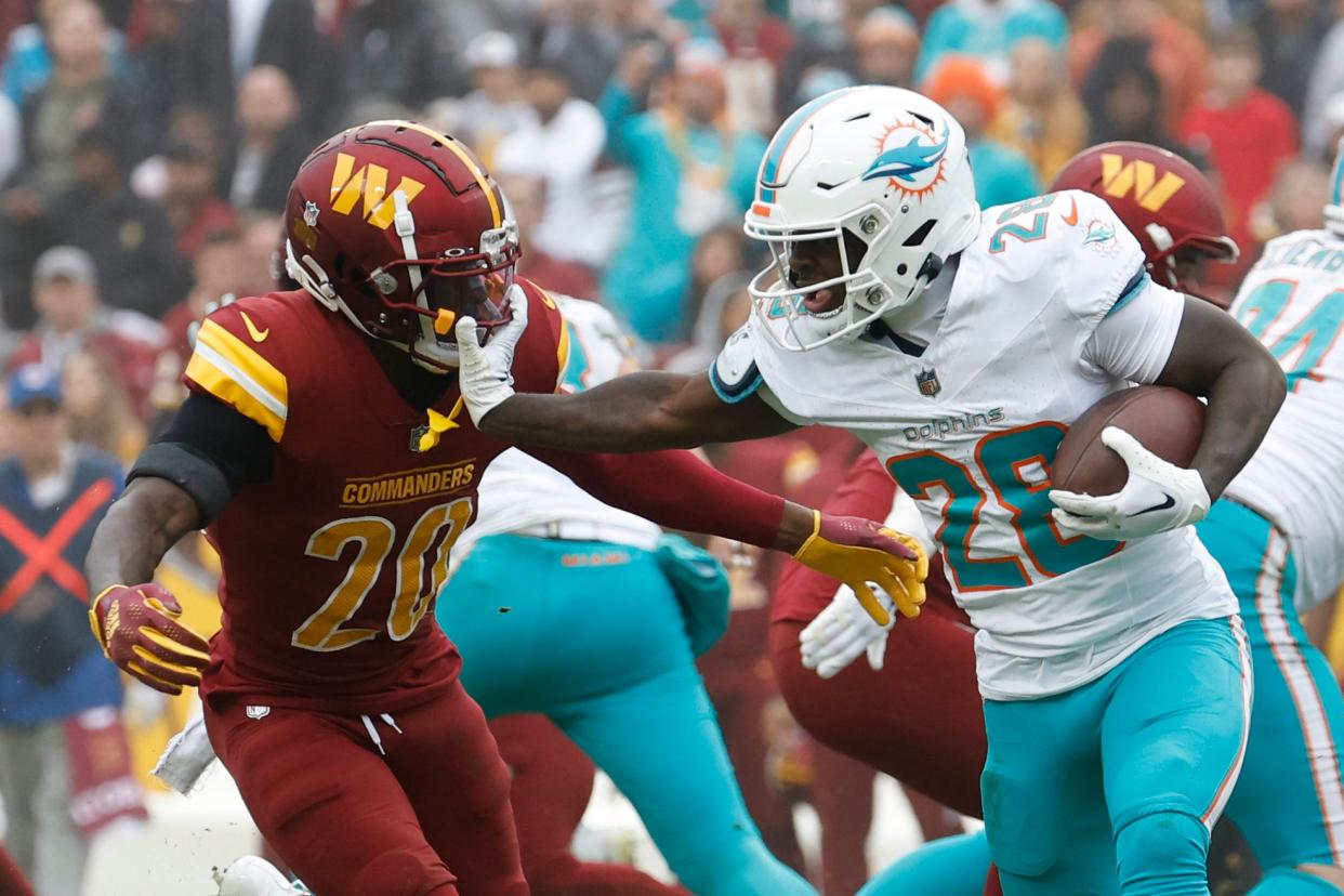 Dec 3, 2023; Landover, Maryland, USA; Miami Dolphins running back De'Von Achane (28) carries the ball as Washington Commanders safety Jartavius Martin (20) chases during the second quarter at FedExField. Mandatory Credit: Geoff Burke-USA TODAY Sports