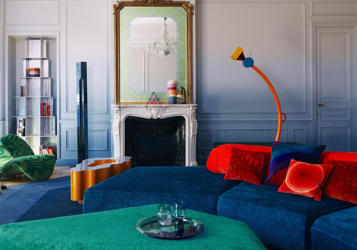  A living room drenched in blue, red and green tones. 