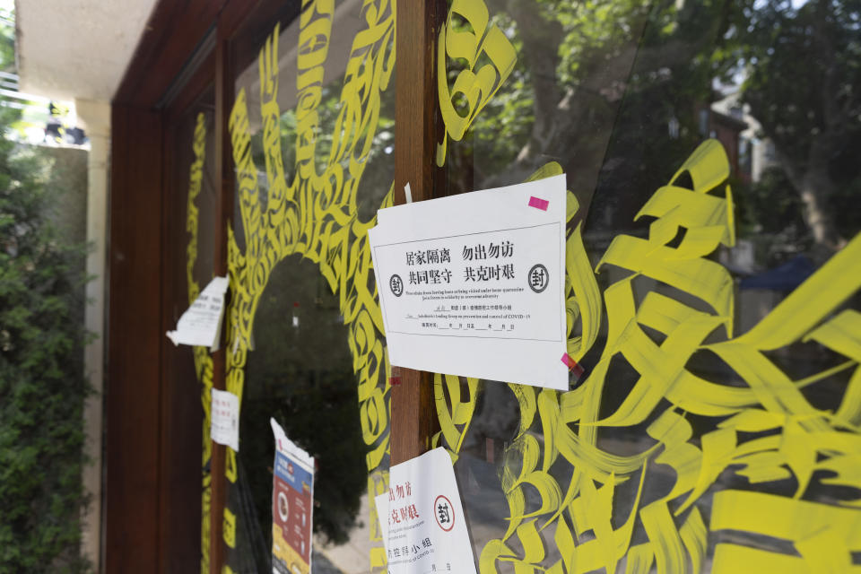 A notice for quarantine is posted outside a store in Shanghai, China, Friday, May 27, 2022. Residents in China's largest city of Shanghai have become bolder in demanding the lifting or easing of coronavirus restrictions that have left millions locked up in their compounds for almost two months. (AP Photo/Andrew Braun)