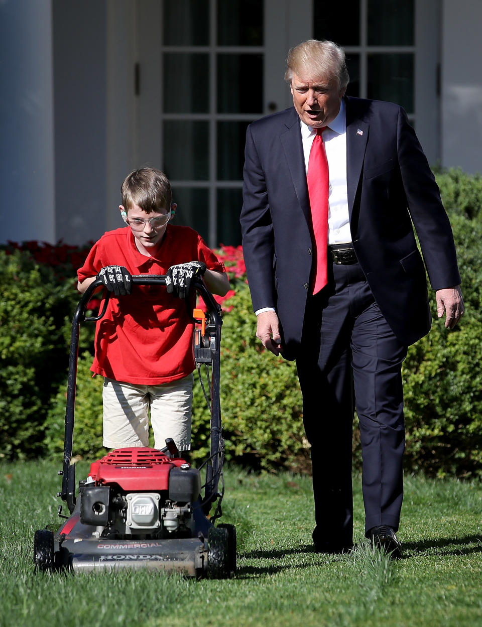 <p>President Donald Trump (R) walks with 11-year-old Frank “FX” Giaccio (L) while he mows the grass in the Rose Garden of the White House September 15, 2017 in Washington, DC. Giaccio, from Falls Church, Virginia, who runs a business called FX Mowing, wrote a letter to Trump expressing admiration for Trump’s business background and offered to mow the White House grass. (Photo: Win McNamee/Getty Images) </p>