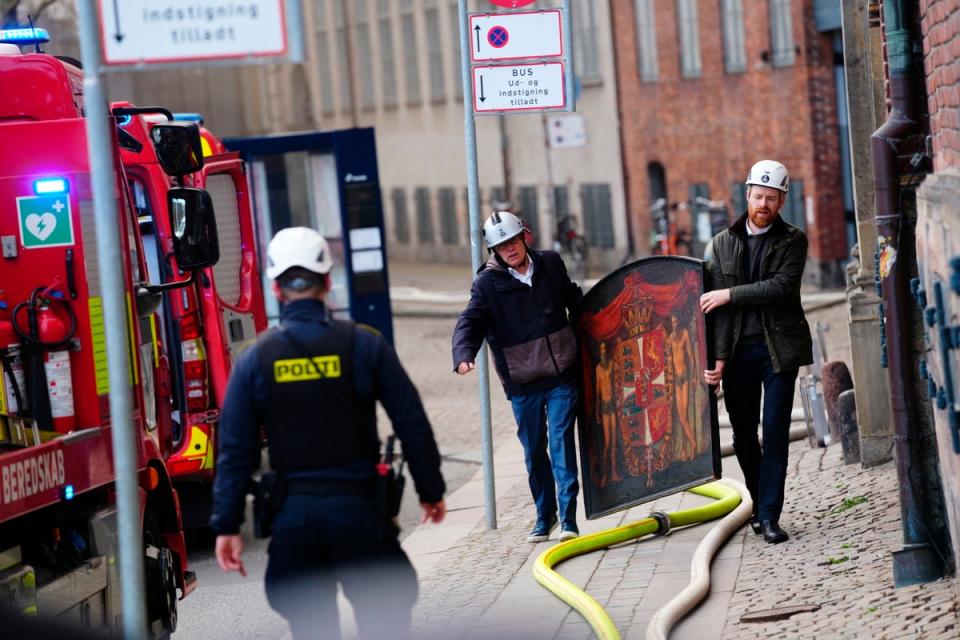A painting is salvaged from the flames of the Boersen stock exchange building in Copenhagen during Tuesday’s fire (Ritzau Scanpix/AFP via Getty Ima)