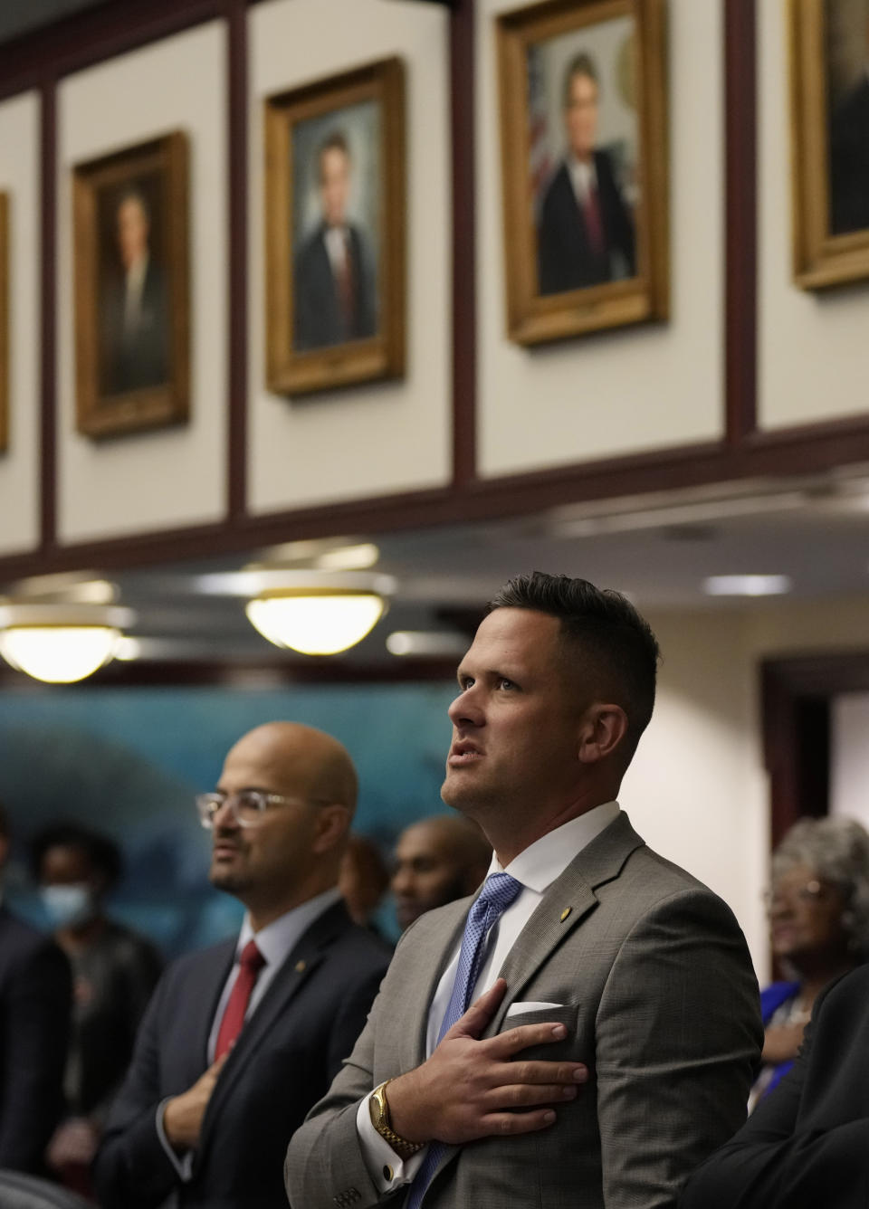 Rep. Joe Harding, right, and other Florida state congressman recite the Pledge of Allegiance during the opening of a special legislative session targeting COVID-19 vaccine mandates, Monday, Nov. 15, 2021, at the Capitol in Tallahassee, Fla. Republican-backed legislation, co-sponsored by Harding, in Florida that could severely limit discussion of gay and lesbian issues in public schools is being widely condemned as dangerous and discriminatory, with one gay Democratic lawmaker saying it’s an attempt to silence LGBTQ students, families and history. (AP Photo/Rebecca Blackwell, File)