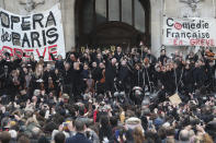 Striking opera musicians wave to the crowd after performing outside the Palais Garnier opera house, Saturday, Jan. 18, 2020 in Paris. As some strikers return to work, with notable improvements for train services that have been severely disrupted for weeks, more radical protesters are trying to keep the movement going. Musicians, singers and other members of the striking Paris Opera drew a crowd with a free concert in front of the Palais Garnier opera house. (AP Photo/Thibault Camus)