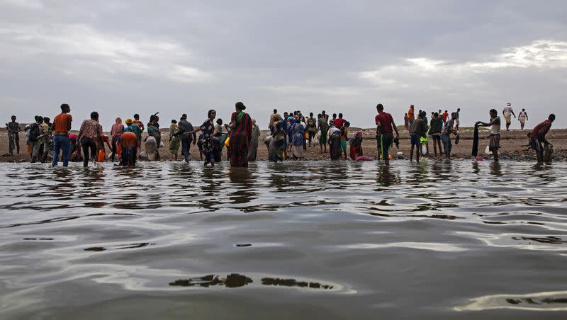 Ethiopian migrants walk on the shores of Ras al-Ara, Lahj, Yemen, after disembarking from a boat, July 26, 2019. 