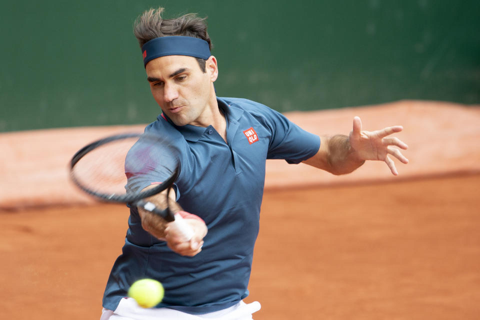 Roger Federer of Switzerland returns a ball to Pablo Andujar of Spain during their men's second round match, at the ATP 250 Geneva Open tournament in Geneva, Switzerland, Tuesday, May 18, 2021. The matches of the Geneva Open are played in front of 100 spectators due to preventive measure against the spread the coronavirus COVID-19. (Salvatore Di Nolfi/Keystone via AP)