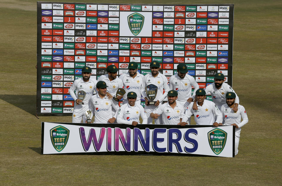 Pakistan's team pose for a photograph with the winning trophy of the test series at the end of the second cricket test match between Pakistan and South Africa at the Pindi Stadium in Rawalpindi, Pakistan, Monday, Feb. 8, 2021. (AP Photo/Anjum Naveed)