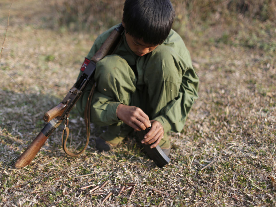 A 15-year-old rebel soldier of the Myanmar National Democratic Alliance Army inserts bullets into the clip of his rifle near a military base in Kokang region. Pictured 2015: REUTERS/Stringer