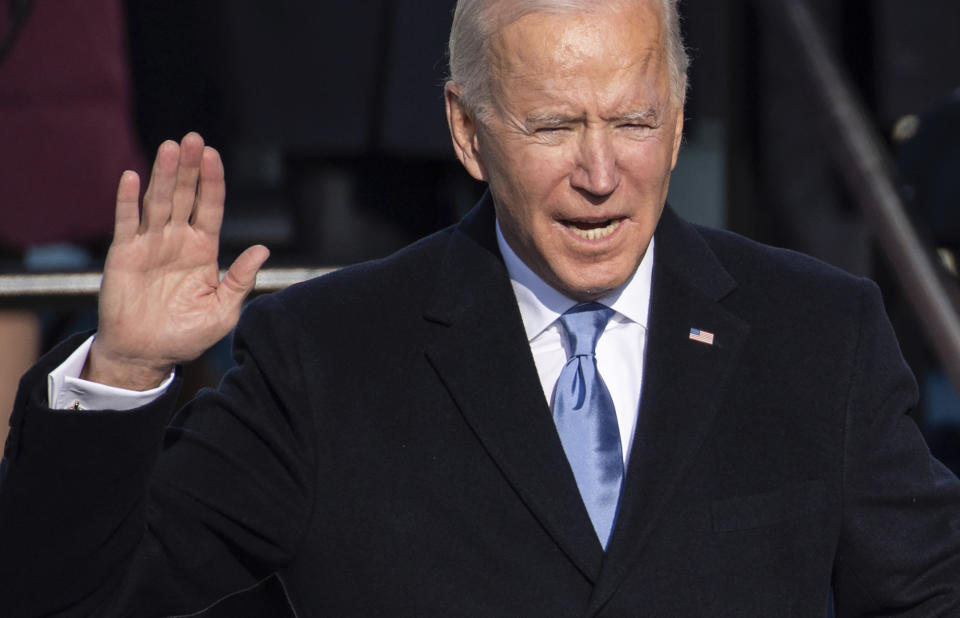 Joe Biden holds up his right hand as he is sworn in as the 46th president of the United States during the 59th Presidential Inauguration at the U.S. Capitol in Washington, Wednesday, Jan. 20, 2021. (Saul Loeb/Pool Photo via AP)