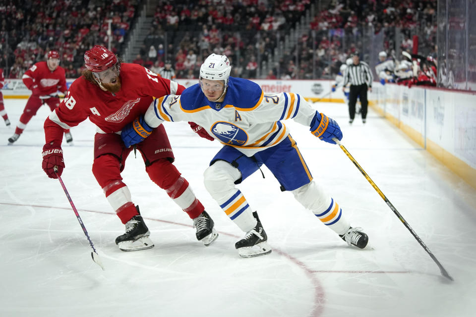 Buffalo Sabres right wing Kyle Okposo (21) protects the puck from Detroit Red Wings defenseman Marc Staal (18) in the first period of an NHL hockey game Saturday, Jan. 15, 2022, in Detroit. (AP Photo/Paul Sancya)