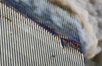 <p>A person falls from the north tower of New York's World Trade Center as another clings to the outside, left, while smoke and fire billow from the building, Tuesday Sept. 11, 2001. (AP Photo/Richard Drew)</p> 