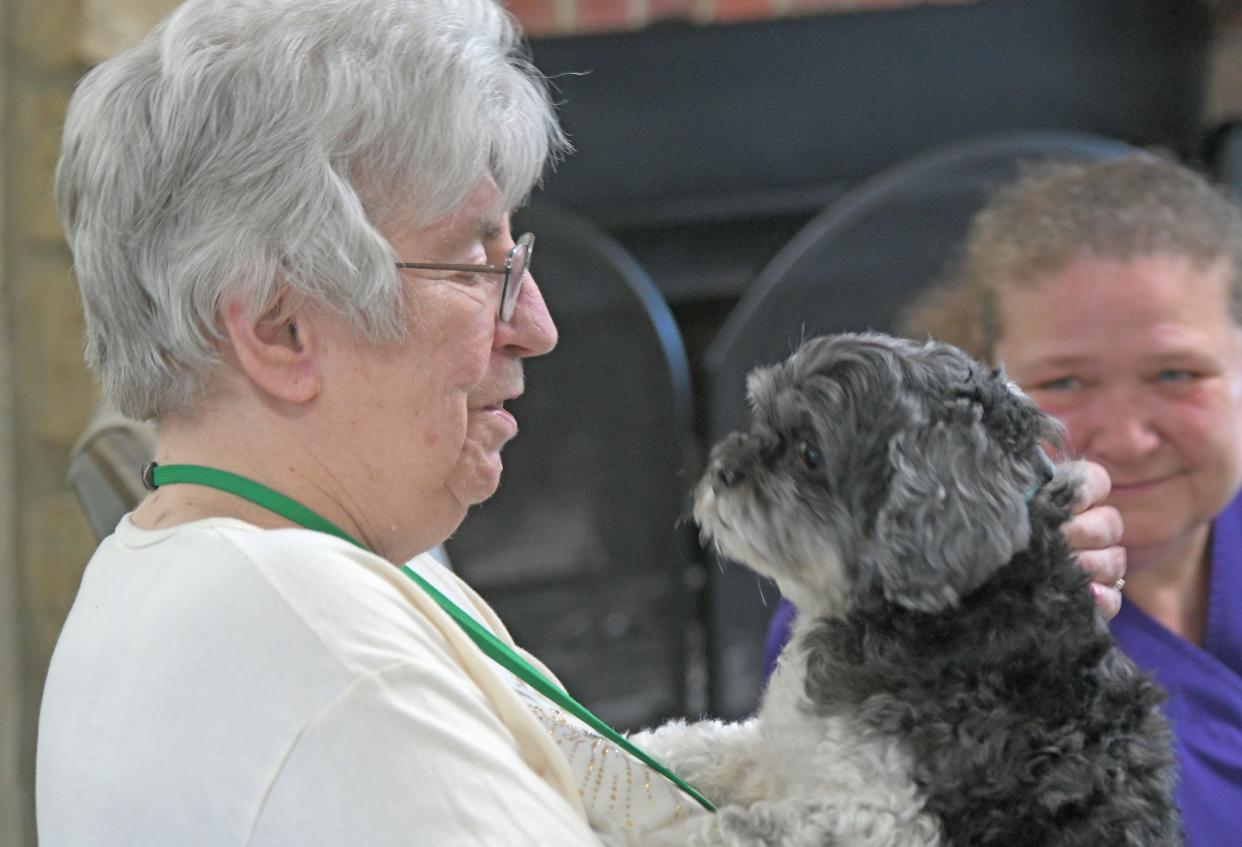 Norma Domer and "Chance" share a quiet moment Thursday afternoon at Trustwell Living at Mansfield Place while celebrating National Pet Day.