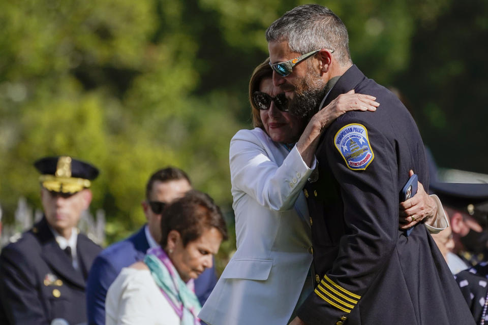 House Speaker Nancy Pelosi of Calif., hugs Washington Metropolitan Police Department officer Michael Fanone as they arrive for a bill signing that awards Congressional gold medals to law enforcement officers that protected members on Congress at the Capitol during the Jan. 6 riots, in the Rose Garden of the White House, Thursday, Aug. 5, 2021, in Washington. (AP Photo/Evan Vucci)