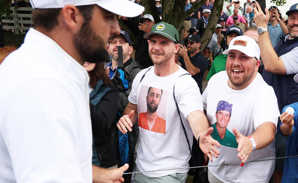 Scottie Scheffler, pictured here with fans wearing t-shirts with his face on them.