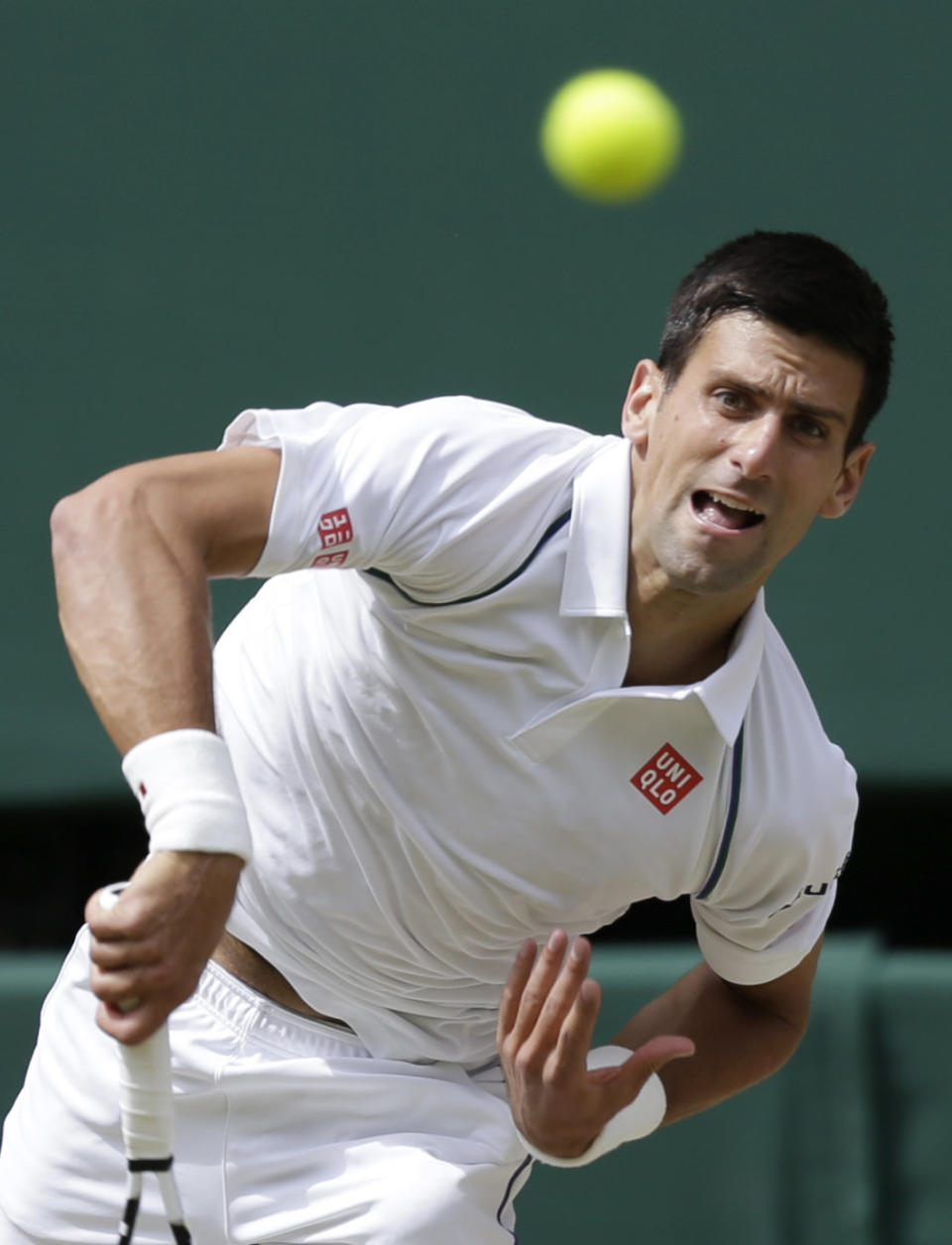 Novak Djokovic of Serbia serves to Roger Federer of Switzerland during the men's singles final at the All England Lawn Tennis Championships in Wimbledon, London, Sunday July 12, 2015. (AP Photo/Pavel Golovkin)