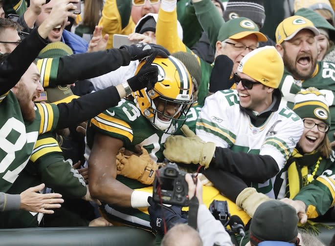 Green Bay Packers' Aaron Jones celebrates a touchdown run with Packers fans last season. (AP)