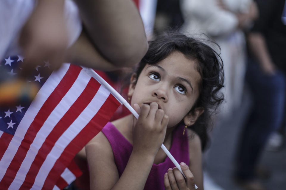 <p>First generation Yemeni-American Ghadeer Almontaser, 5, of Brooklyn, holds an American flag as protesters hold a rally outside of Manhattan Federal Court on June 26, 2018 in New York City. (Photo: Byron Smith/Getty Images) </p>