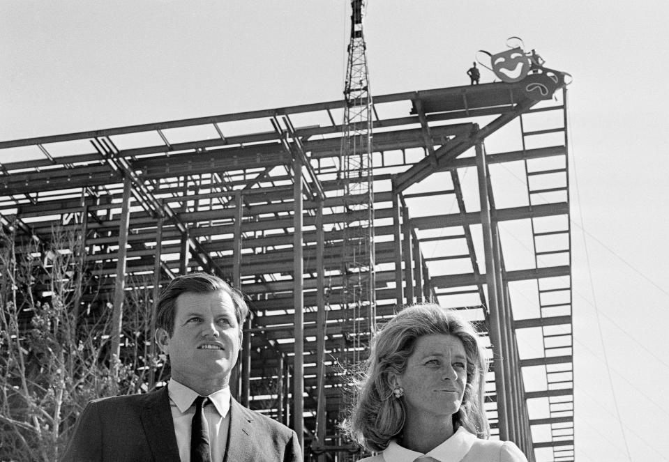 Sen. Edward M. Kennedy (D-Mass.), stands beside his sister, Jean Smith, at a topping out ceremony at the John F. Kennedy Center for the Performing Arts in Washington, Sept. 30, 1968. The center was topped out with a steel replica of the classical Greek masks of comedy (Thalia) upper right, and tragedy (Melpomene). The masks, weighting 900 pounds, were attached to the top of the steel girder of the center's theater.